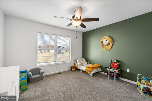 a spacious bedroom with a bed and a window