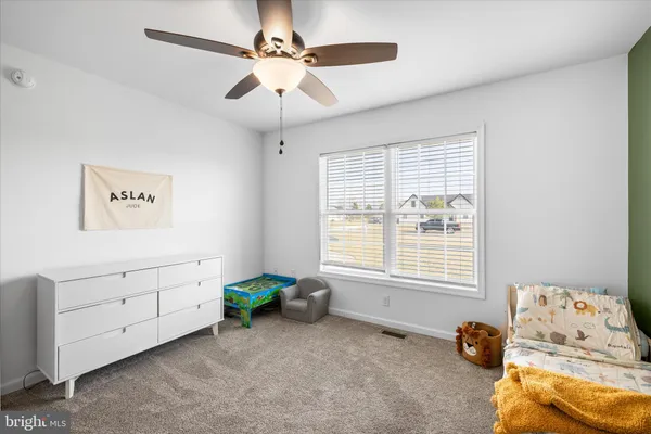 a children room with toys and a chandelier fan