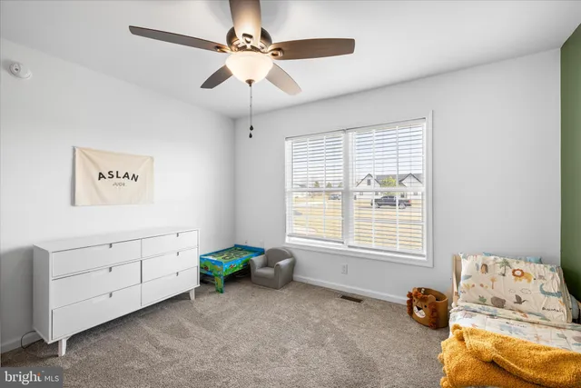 a children room with toys and a chandelier fan