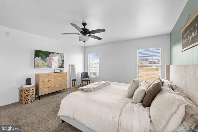 a en suite bathroom with a granite countertop sink and a mirror
