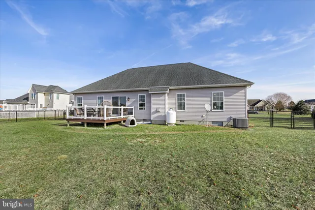 a green field with lots of trees in it
