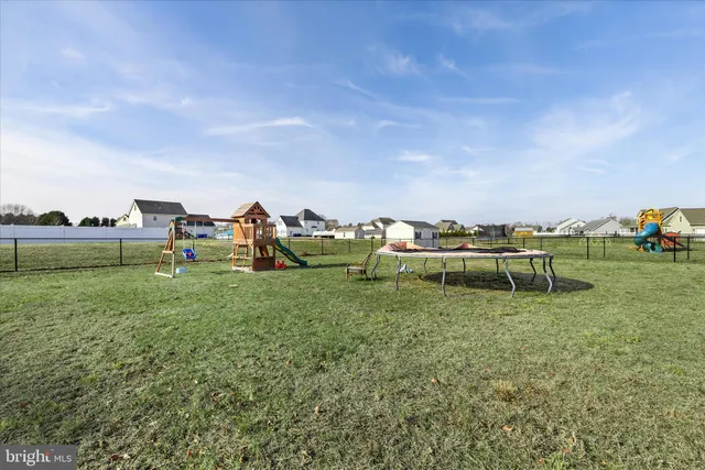 a view of an house with backyard space and lake view