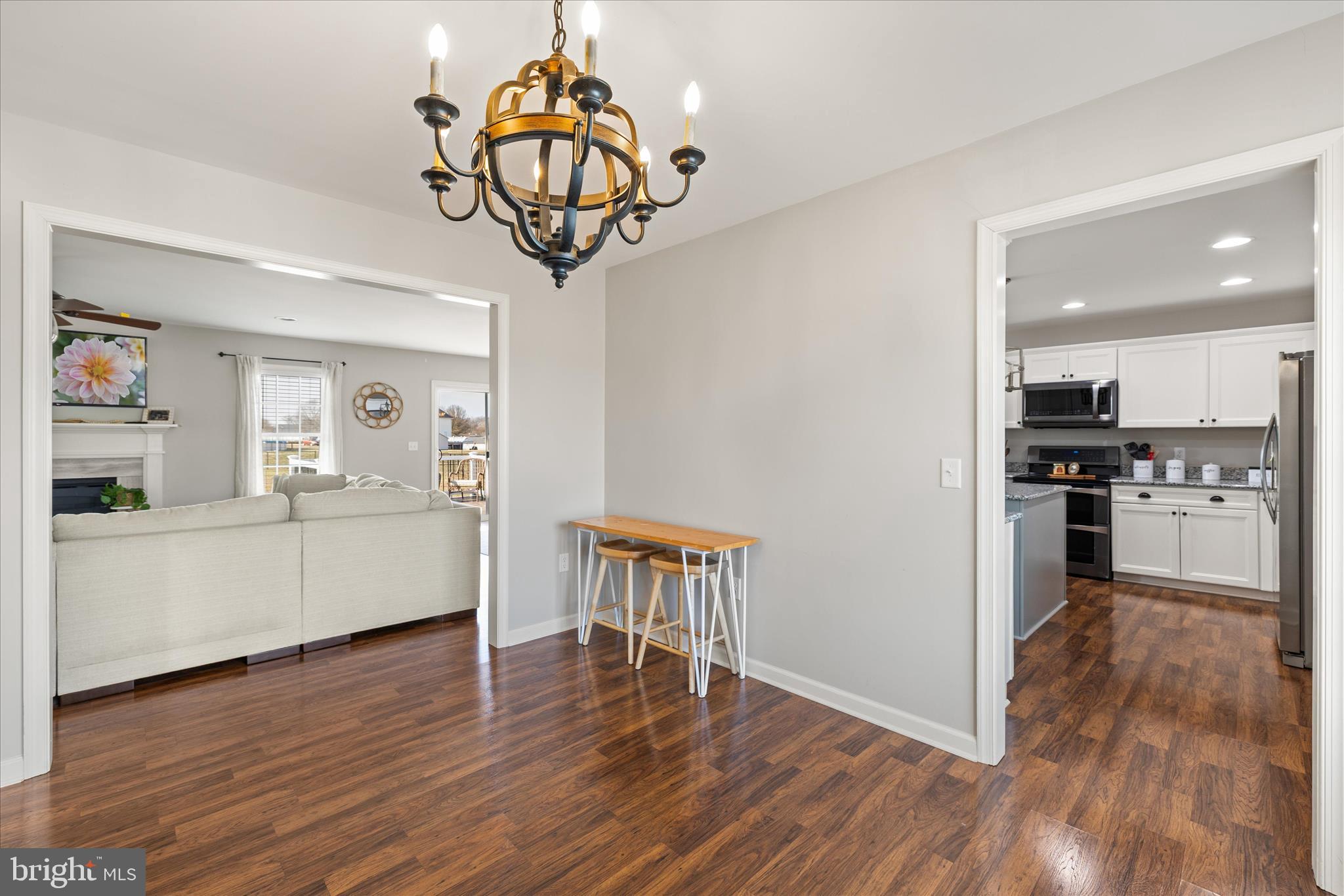 36831 Red Berry Road Delmar, DE 19940 - Photo 8 of 46 a view of a kitchen with a table wooden floor and a refrigerator