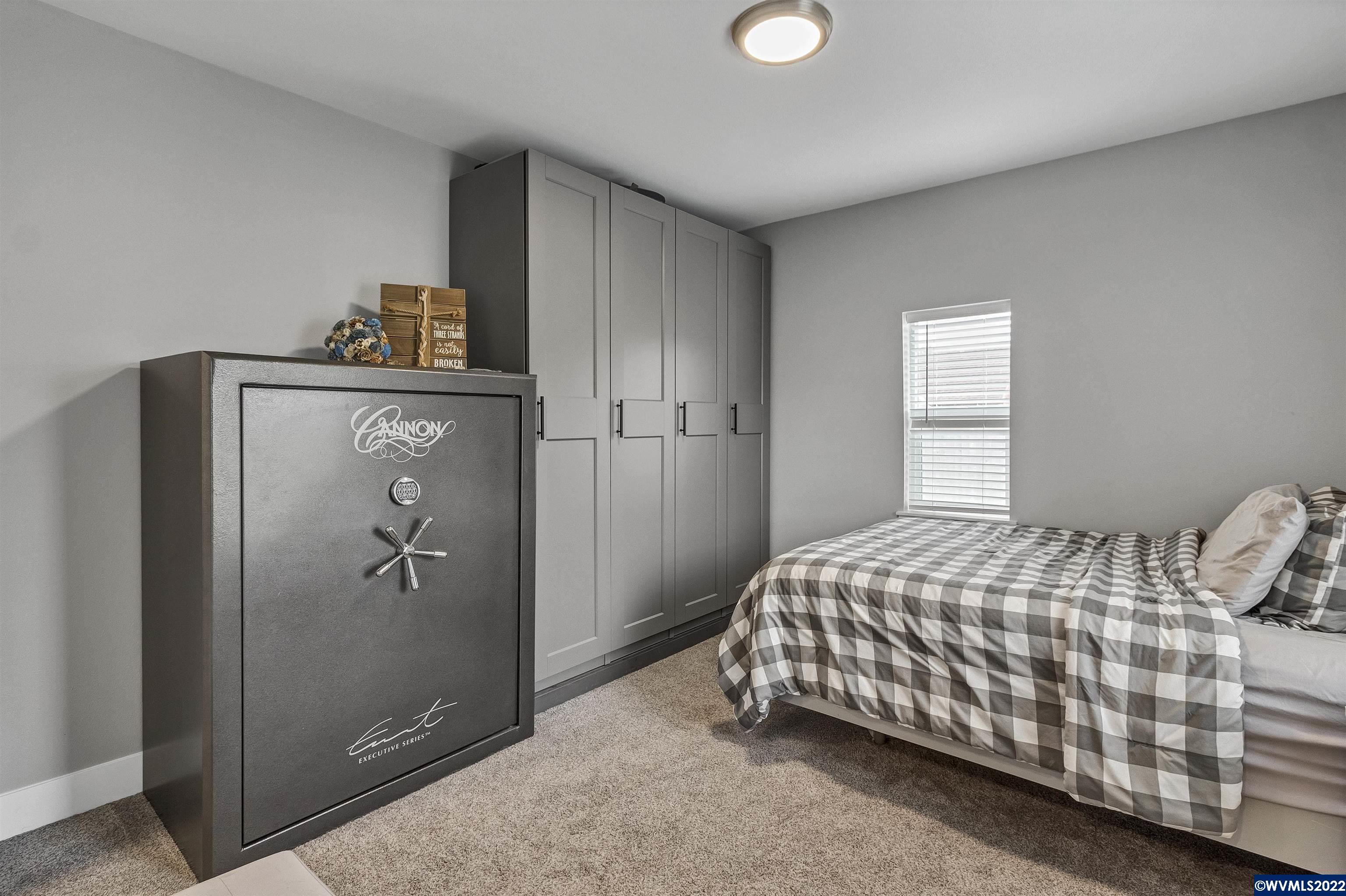 6067 Stayton Road Southeast Turner, OR 97392 - Photo 7 of 31 a bedroom with a bed and a refrigerator