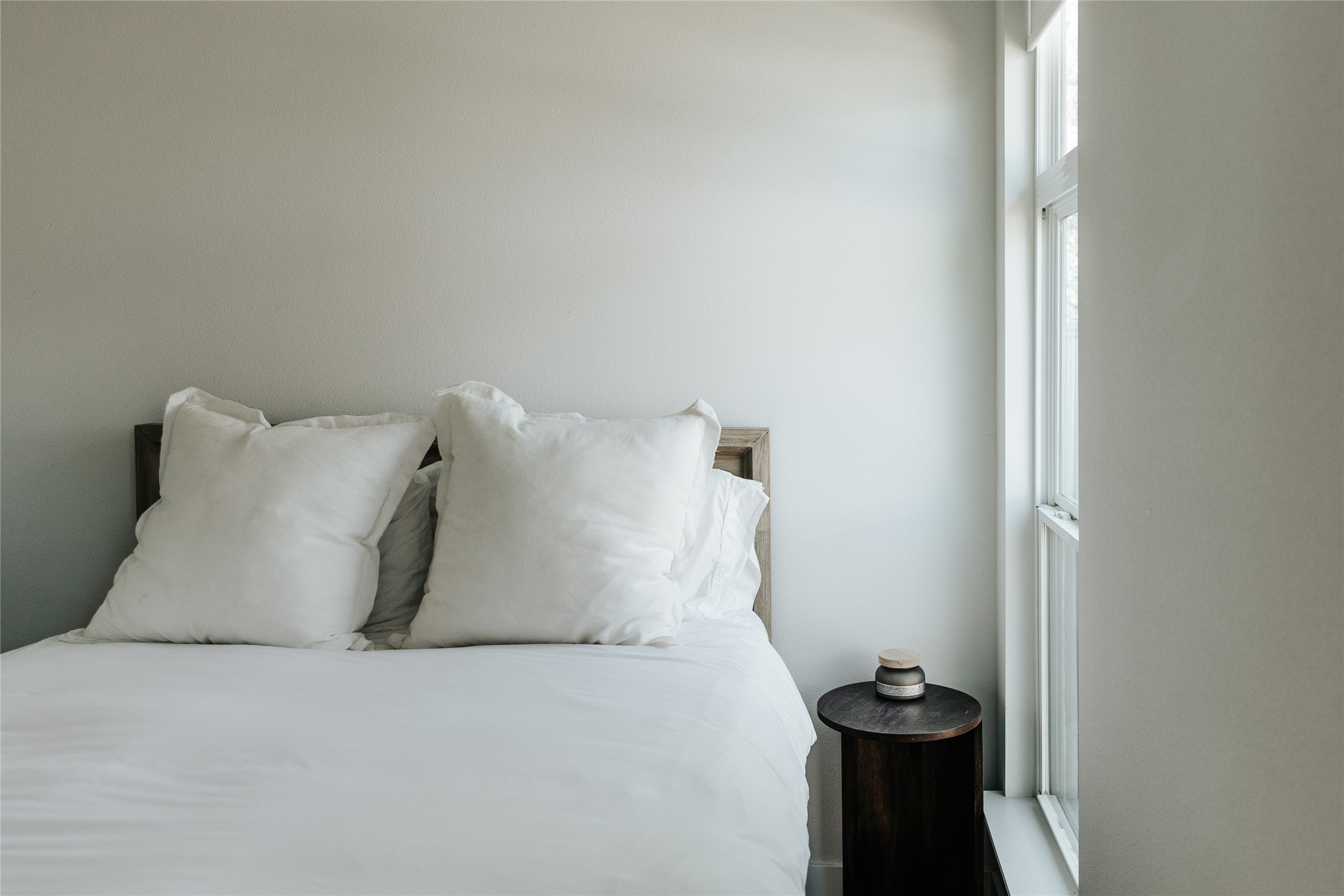 1128 Walton Lane, Unit 2 Austin, TX 78721 - Photo 8 of 30 Natural light filters into this serene bedroom, highlighting a clean, inviting atmosphere.