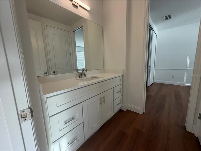 a bathroom with a double vanity sink and mirror