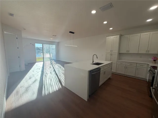 a kitchen with a sink and cabinets