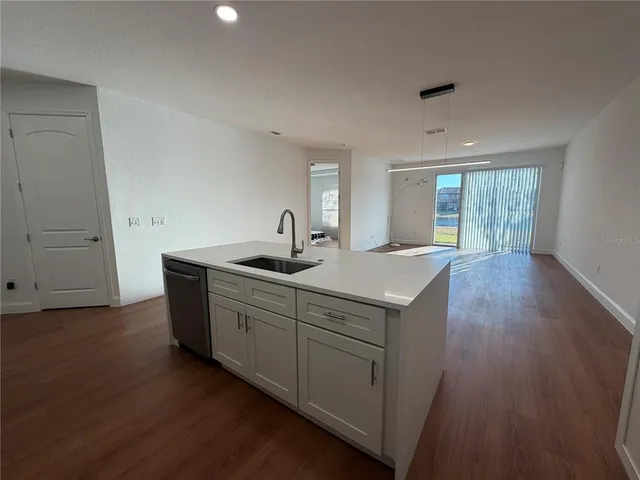 a kitchen with sink stove and cabinets