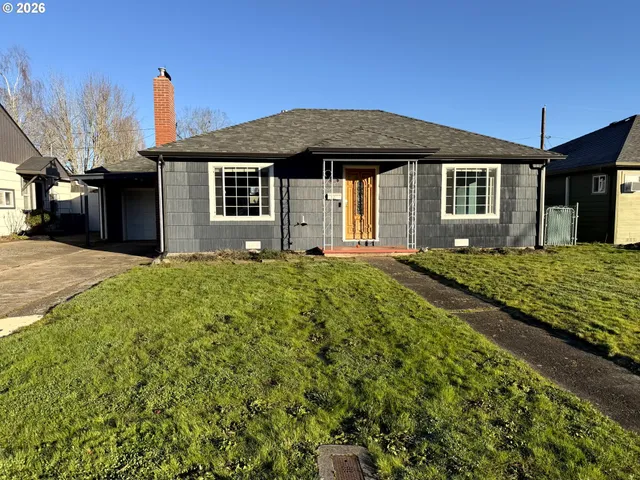 a front view of a house with a garden