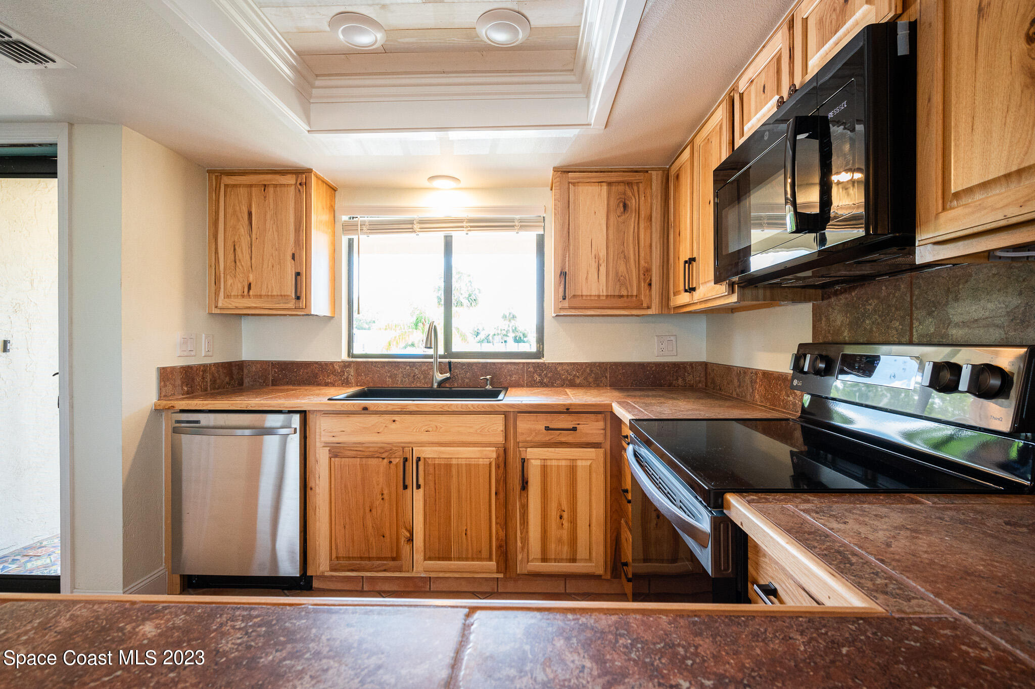 100 Canebreakers Drive, Unit 206 Cocoa, FL 32927 - Photo 11 of 36 a kitchen with stainless steel appliances granite countertop a sink stove and cabinets