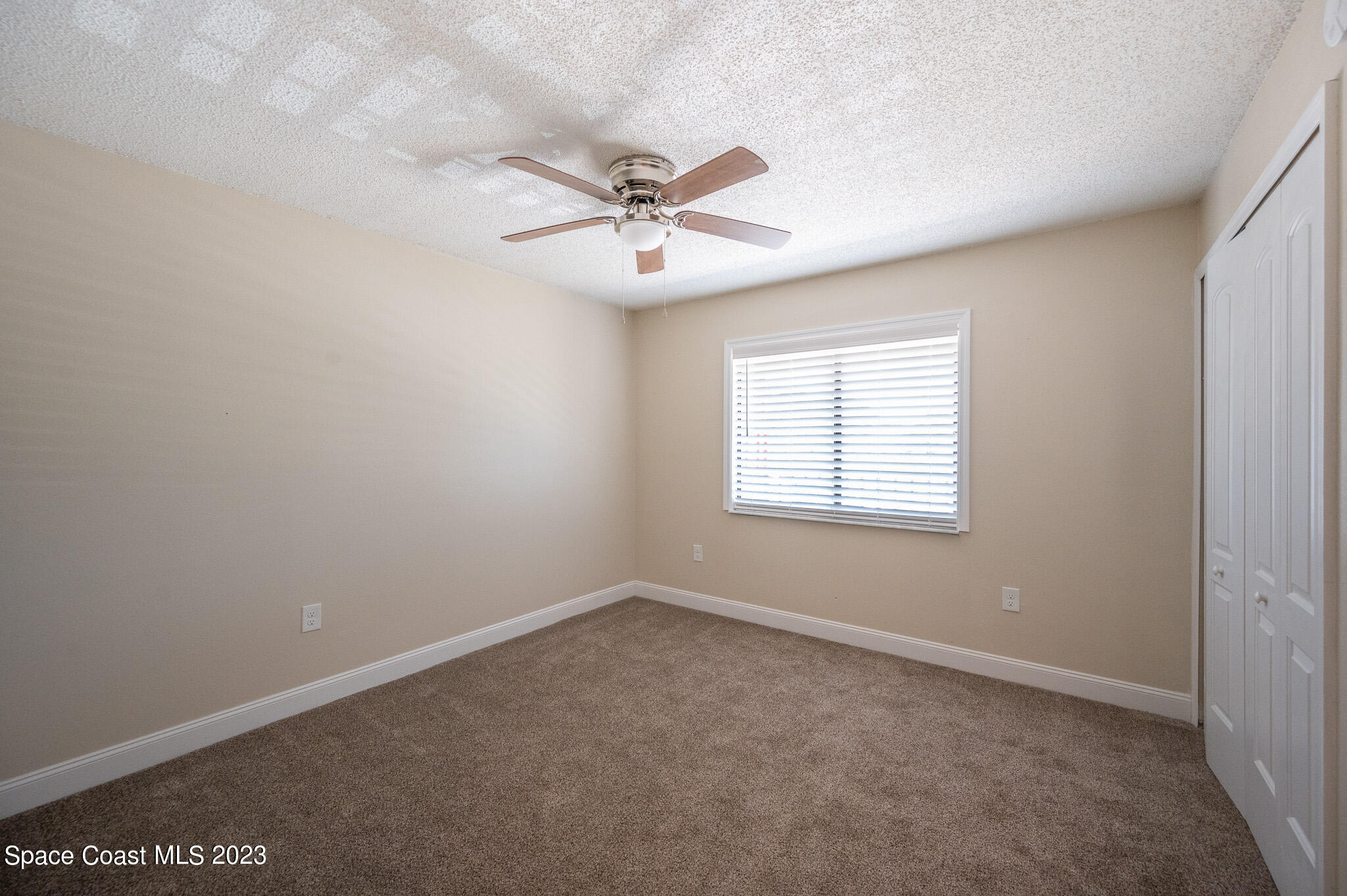 100 Canebreakers Drive, Unit 206 Cocoa, FL 32927 - Photo 21 of 36 an empty room with windows and fan