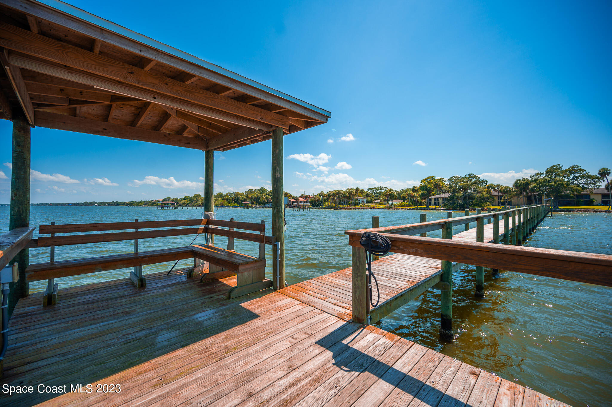 100 Canebreakers Drive, Unit 206 Cocoa, FL 32927 - Photo 29 of 36 a view of a balcony with wooden floor and outdoor seating