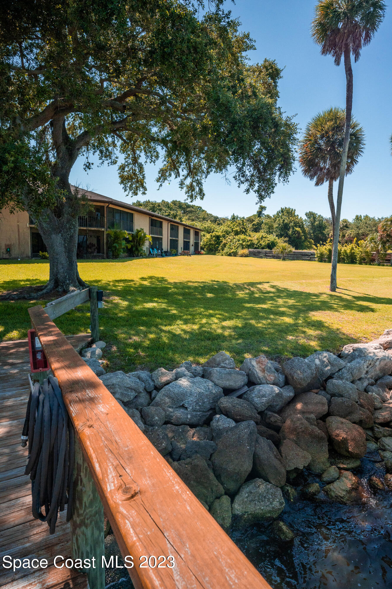 100 Canebreakers Drive, Unit 206 Cocoa, FL 32927 - Photo 33 of 36 a view of a swimming pool with a yard and plants