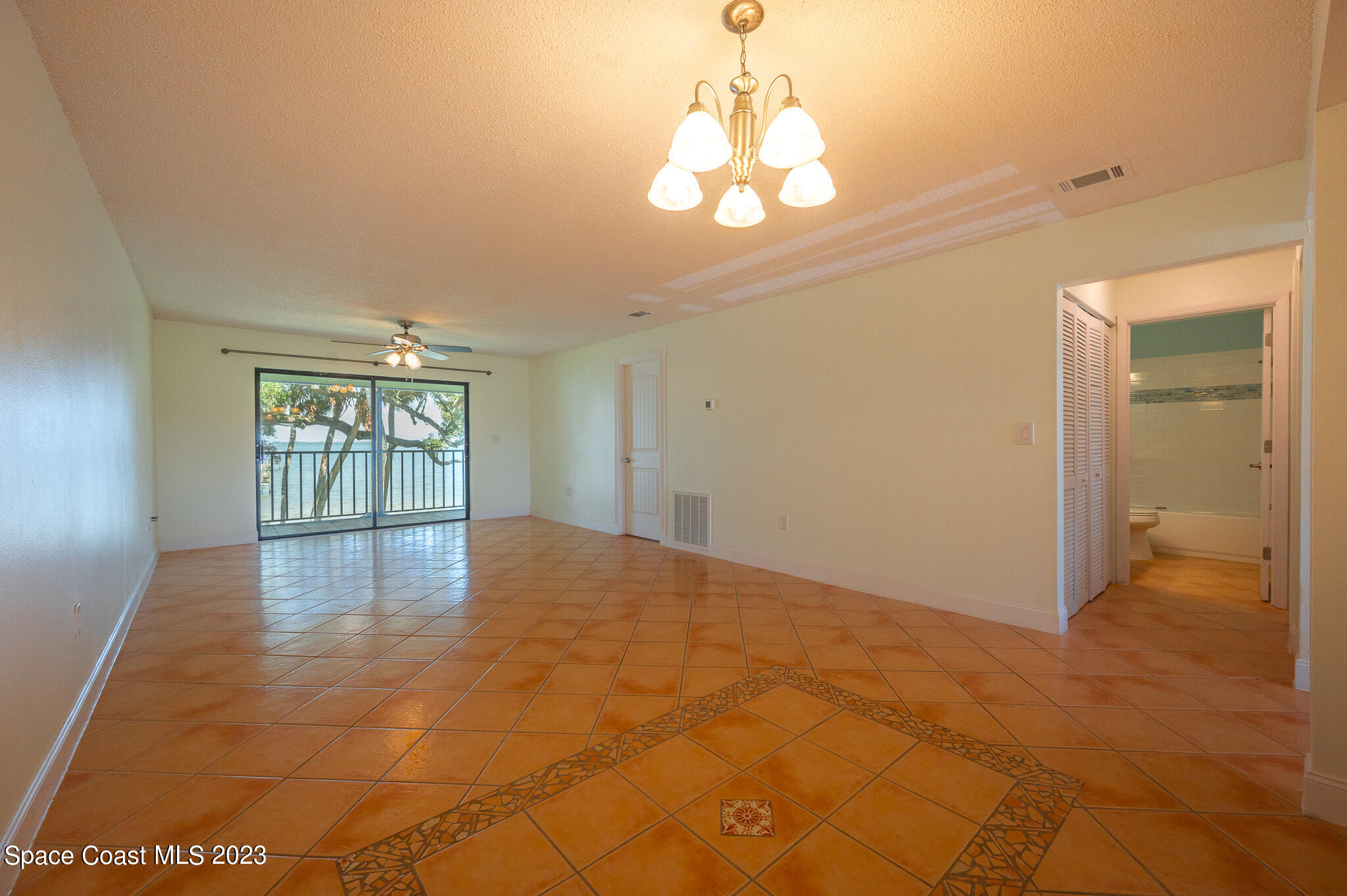 100 Canebreakers Drive, Unit 206 Cocoa, FL 32927 - Photo 4 of 36 a view of an empty room with glass door