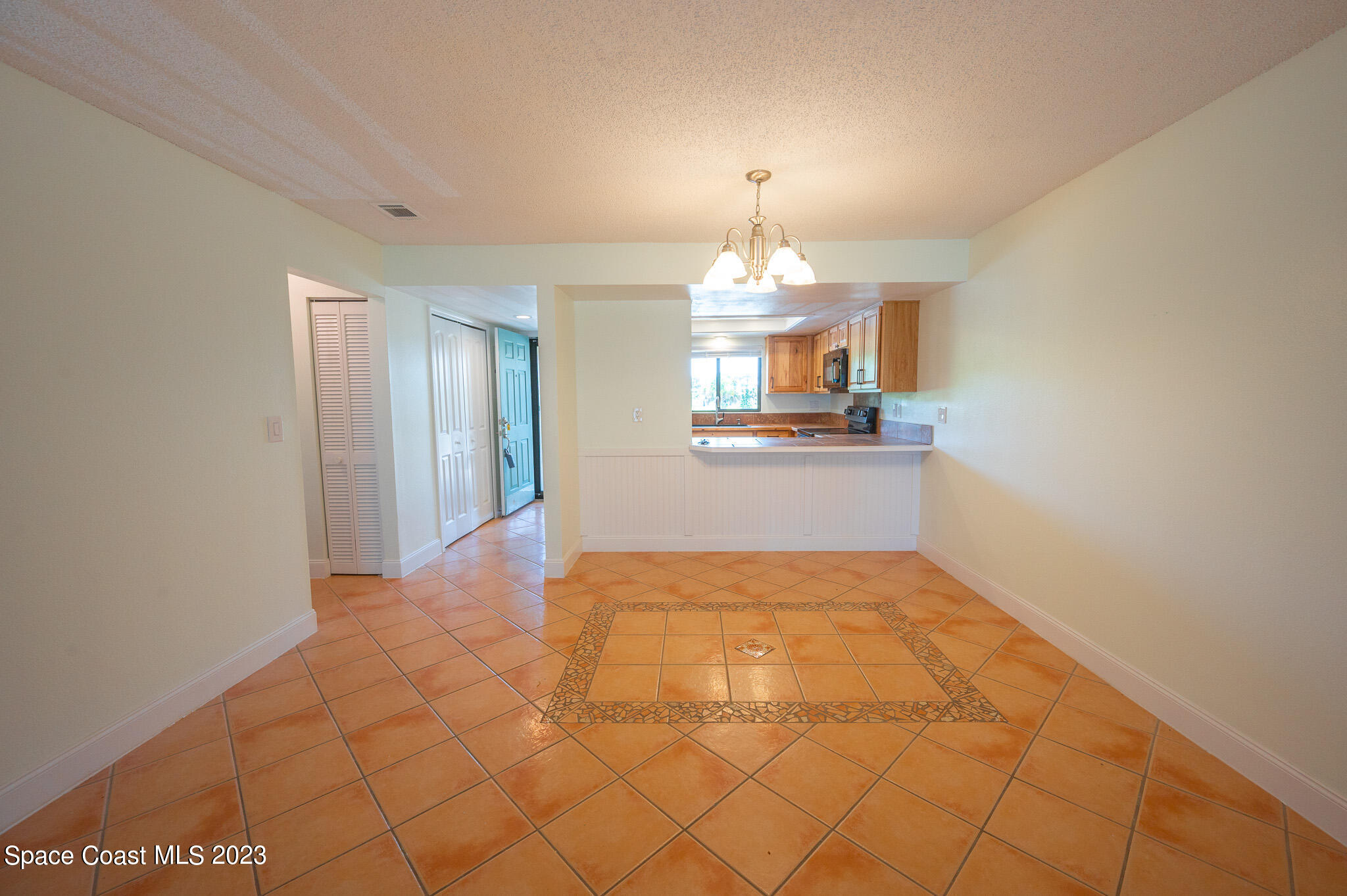 100 Canebreakers Drive, Unit 206 Cocoa, FL 32927 - Photo 6 of 36 a view of a kitchen with a sink and a chandelier