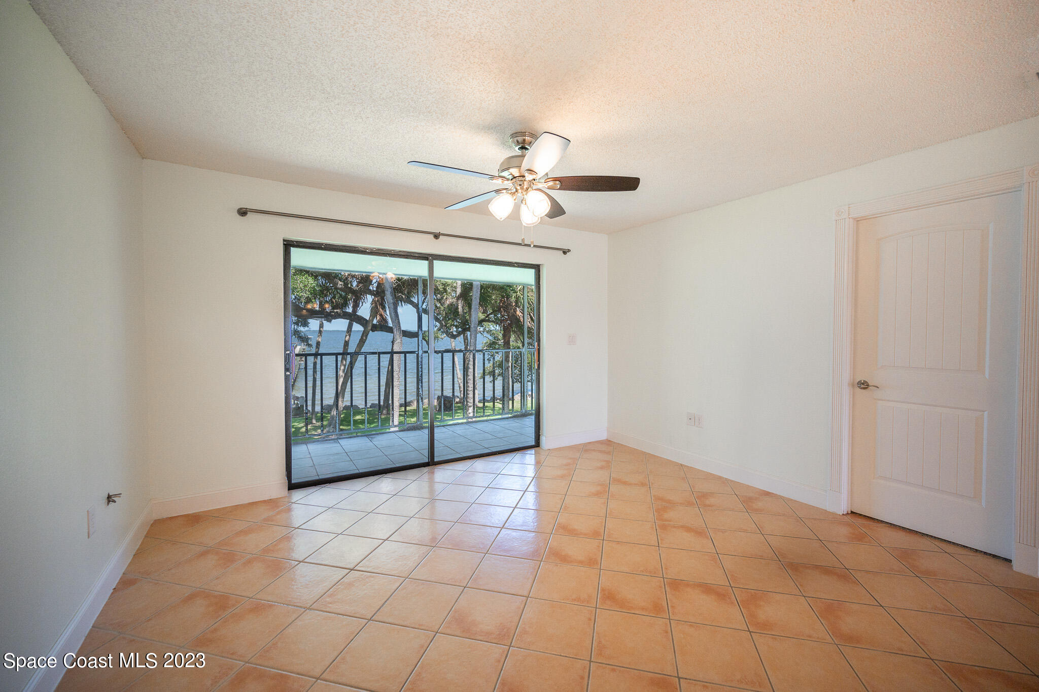 100 Canebreakers Drive, Unit 206 Cocoa, FL 32927 - Photo 7 of 36 a view of a livingroom with a fan a ceiling fan and a large window