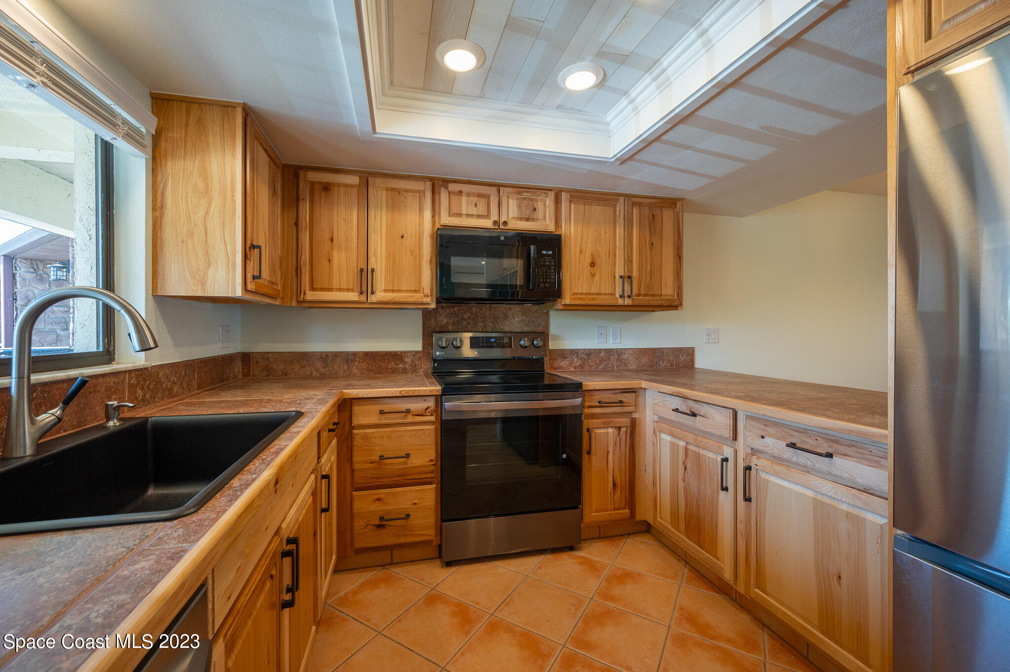 100 Canebreakers Drive, Unit 206 Cocoa, FL 32927 - Photo 8 of 36 a kitchen with stainless steel appliances granite countertop a sink stove and refrigerator