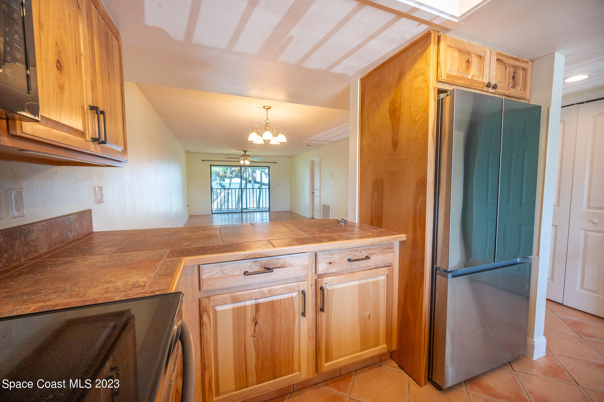 100 Canebreakers Drive, Unit 206 Cocoa, FL 32927 - Photo 9 of 36 a kitchen with stainless steel appliances granite countertop a refrigerator and a stove