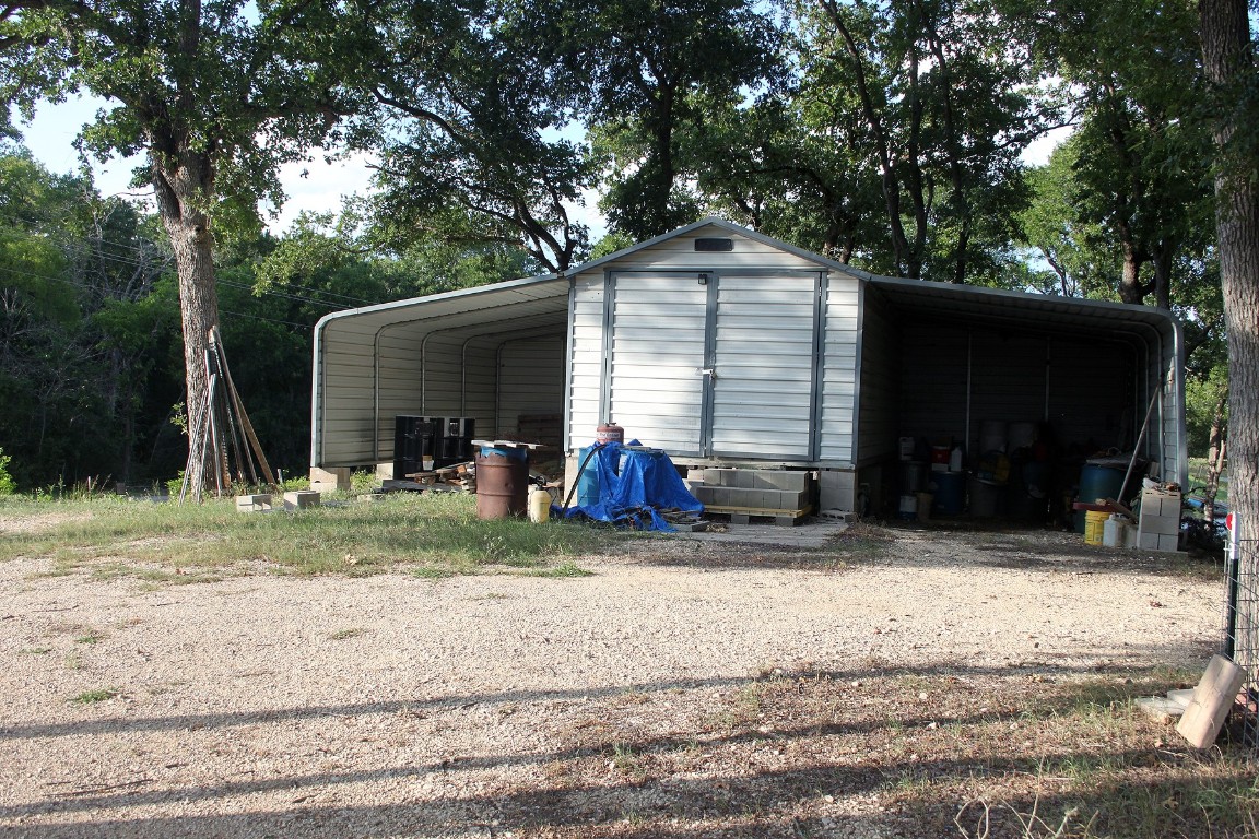 900 Old Lytton Springs Road Lockhart, TX 78644 - Photo 16 of 34 a view of a house with a yard and large tree