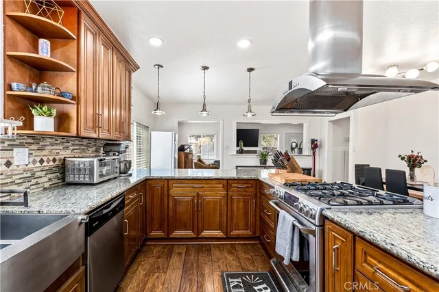 a kitchen with stainless steel appliances granite countertop a stove and a sink