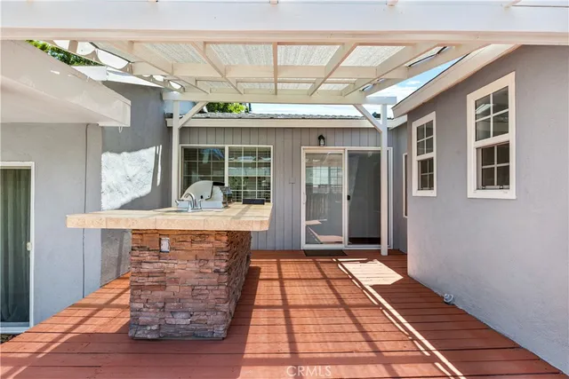 a view of hall with wooden floor and a fireplace