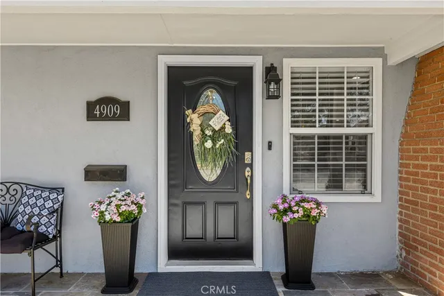 a front view of a house with outdoor seating and a potted plant