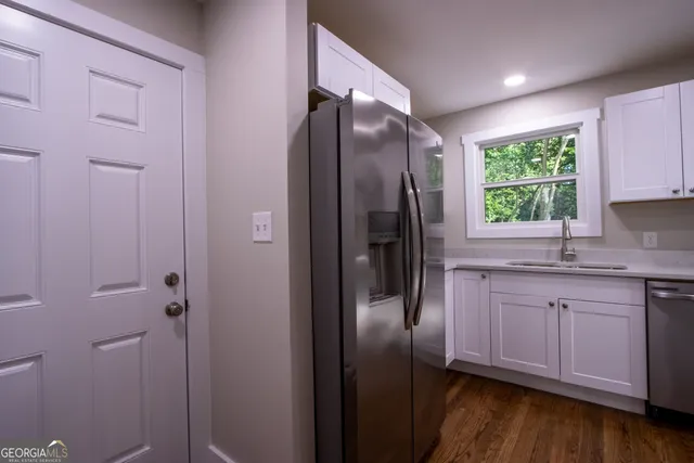 a kitchen with stainless steel appliances granite countertop a refrigerator and a sink