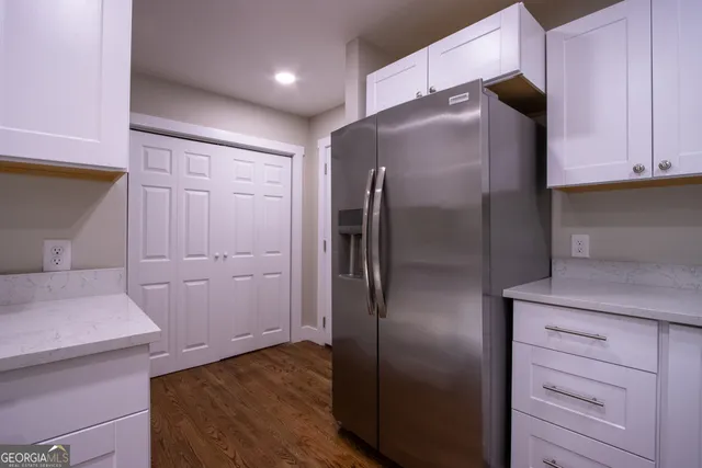 a kitchen with metallic refrigerator freezer and a dishwasher