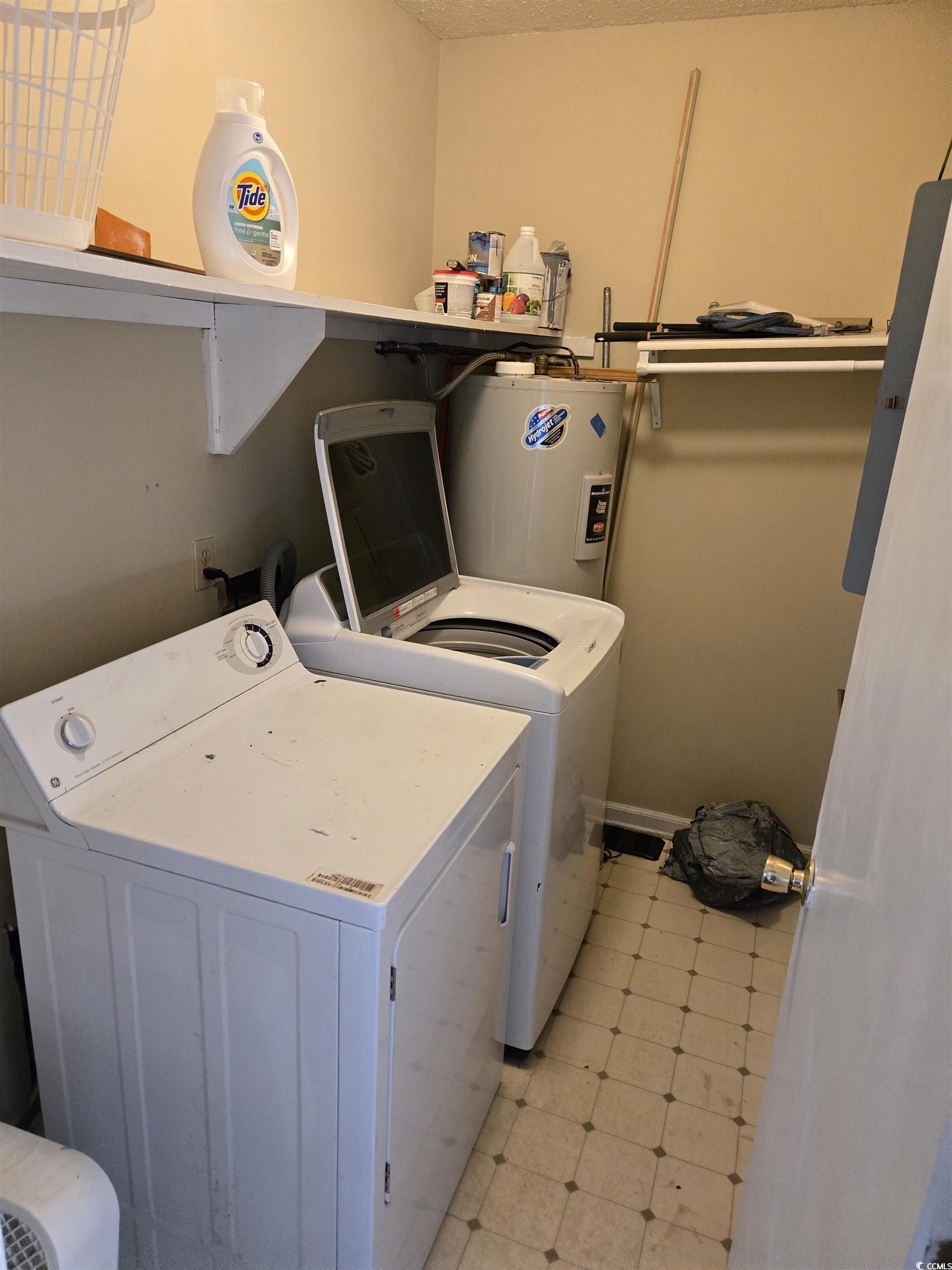 604 35th Avenue North Myrtle Beach, SC 29577 - Photo 8 of 9 Laundry area with light floors, washing machine and dryer, electric water heater, and electric panel