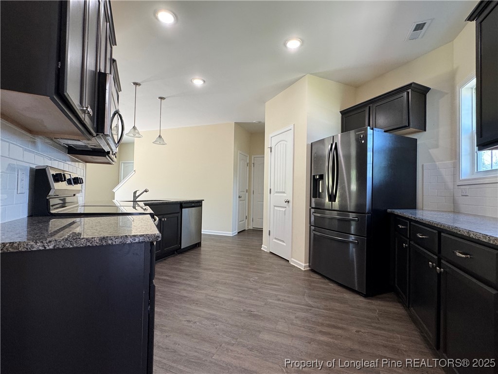 185 Ledgebrook Lane Raeford, NC 28376 - Photo 15 of 32 a kitchen with granite countertop a refrigerator and a sink