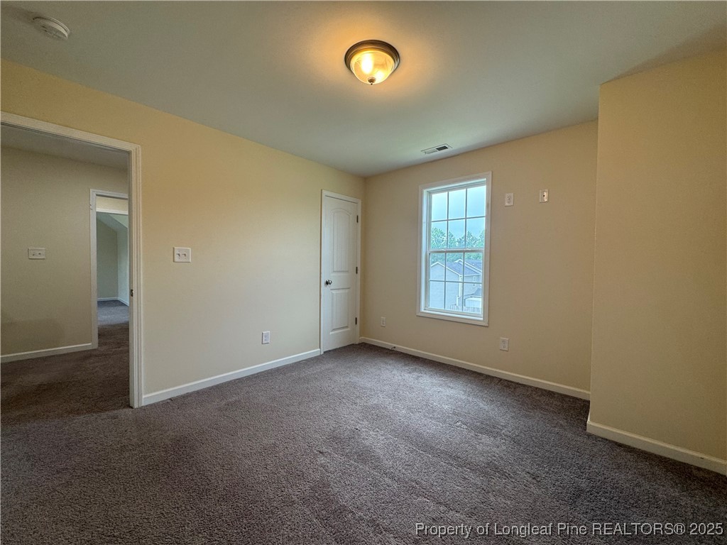 185 Ledgebrook Lane Raeford, NC 28376 - Photo 22 of 32 an empty room with windows and closet