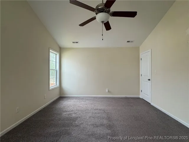 an empty room with wooden floor and cabinet