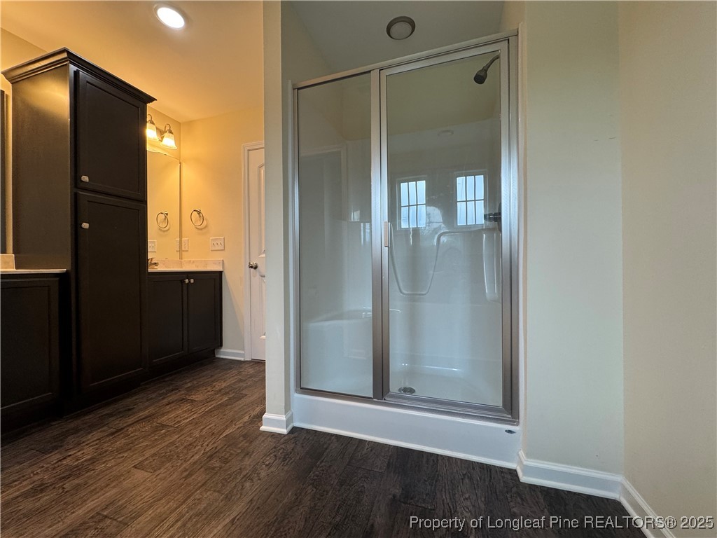 185 Ledgebrook Lane Raeford, NC 28376 - Photo 30 of 32 an empty room with wooden floor and cabinet