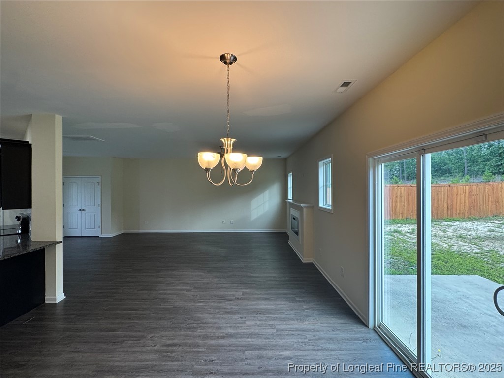 185 Ledgebrook Lane Raeford, NC 28376 - Photo 7 of 32 a view of a livingroom with a chandelier wooden floor and a chandelier