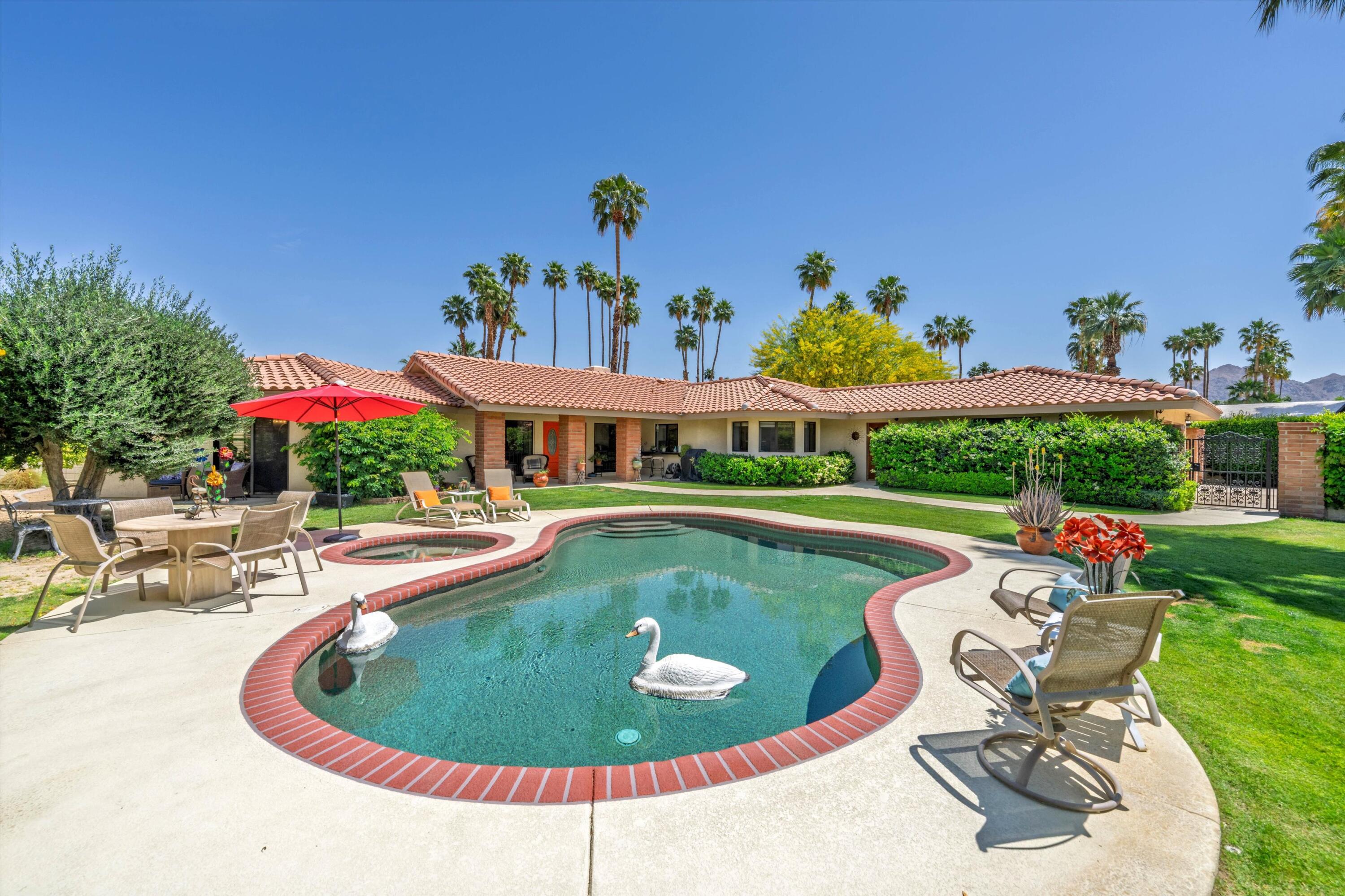 48800 Ave Anselmo La Quinta, CA 92253 - Photo 11 of 44 a view of a swimming pool with a lounge chairs in the patio