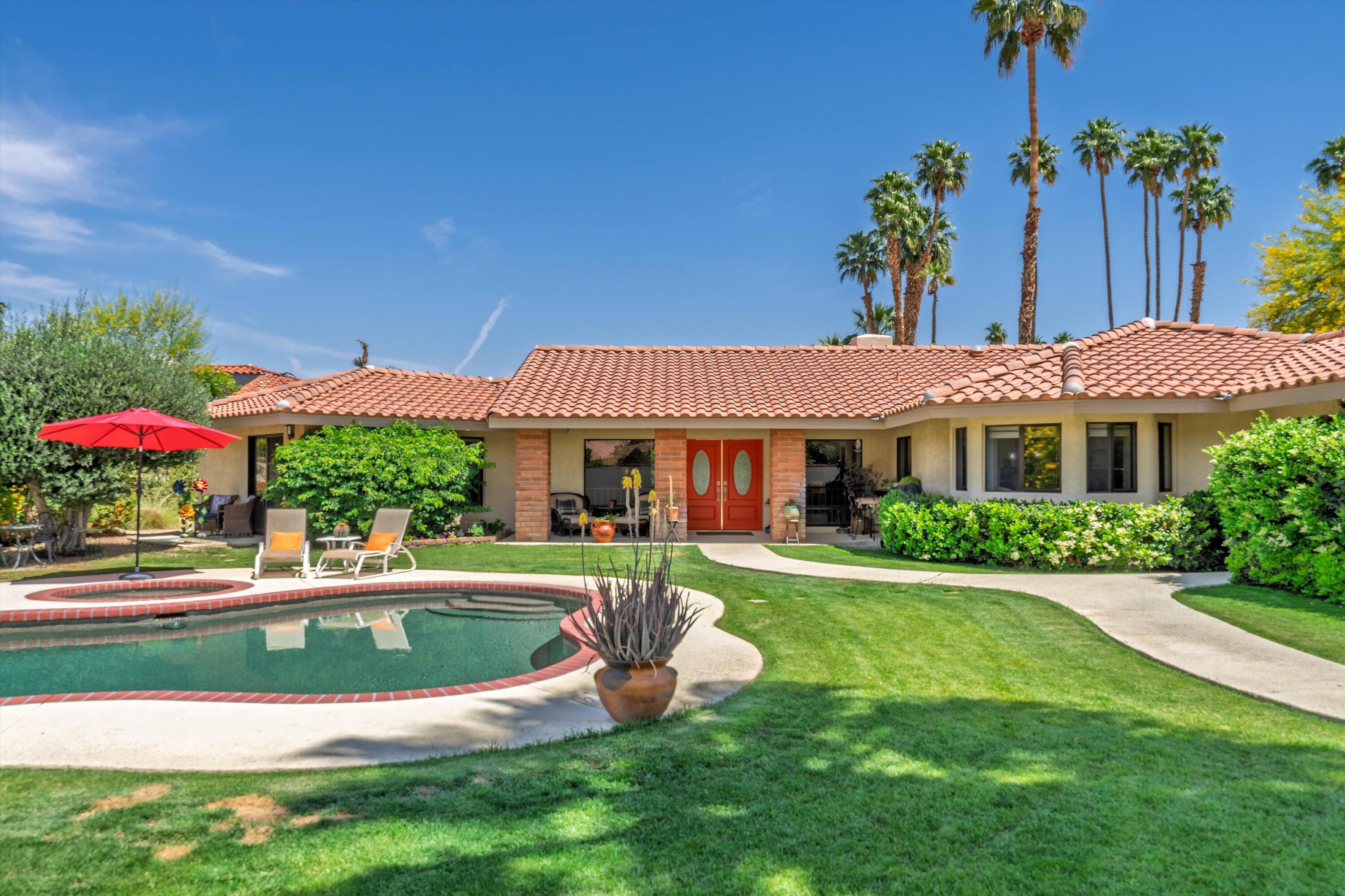 48800 Ave Anselmo La Quinta, CA 92253 - Photo 13 of 44 a front view of a house with a yard