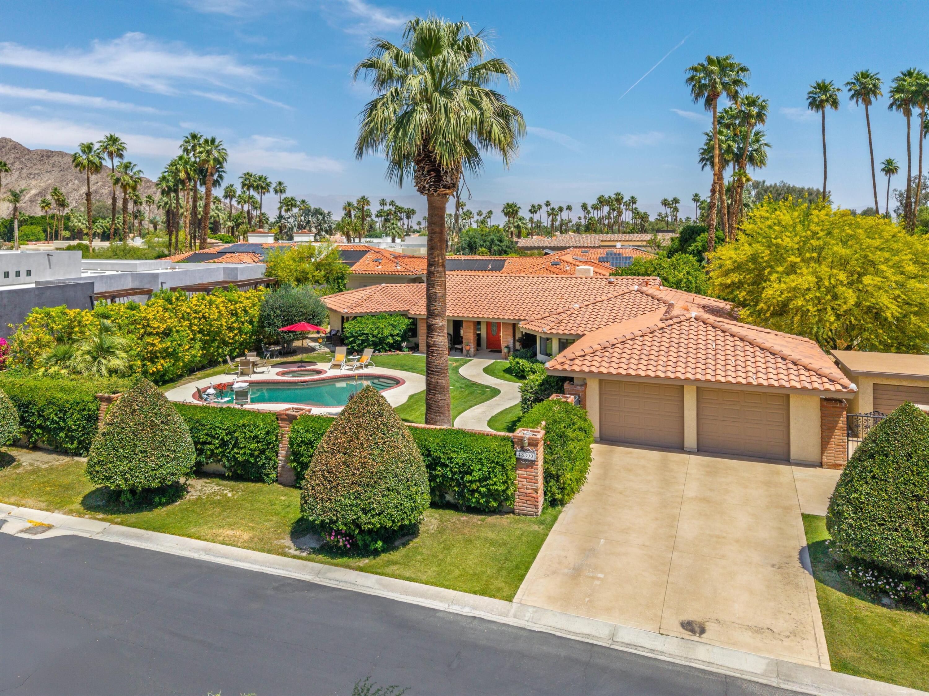 48800 Ave Anselmo La Quinta, CA 92253 - Photo 3 of 44 a front view of a house with garden