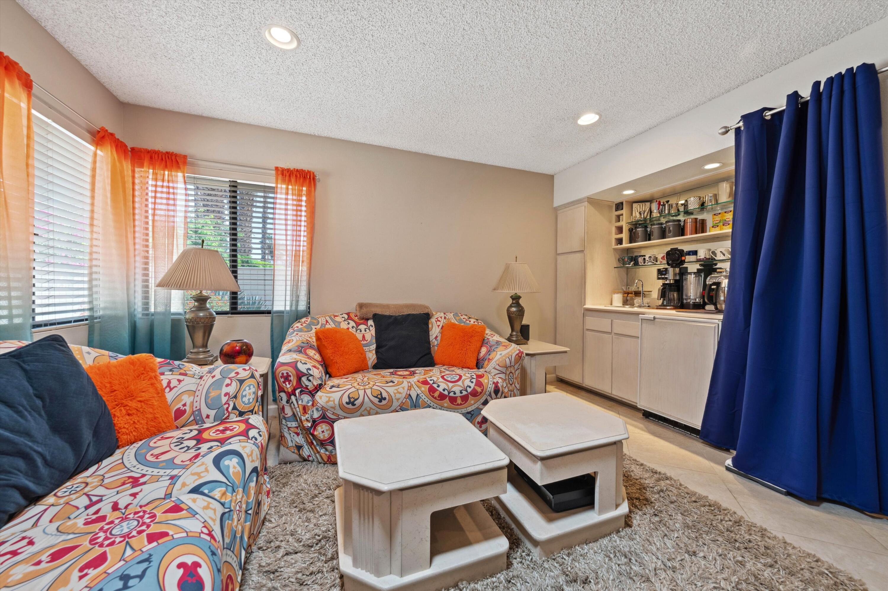 48800 Ave Anselmo La Quinta, CA 92253 - Photo 31 of 44 a living room with furniture a large window and dresser
