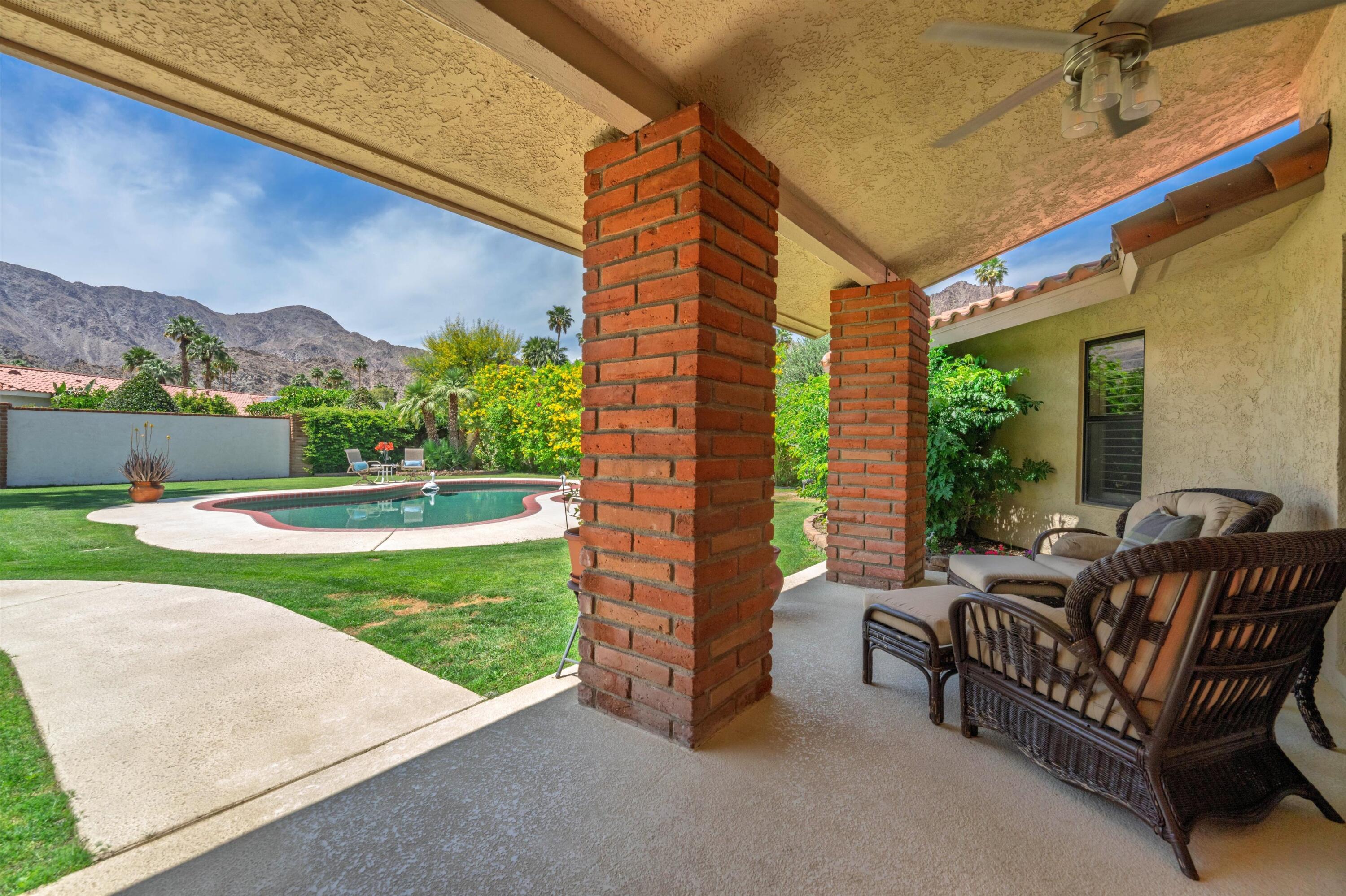 48800 Ave Anselmo La Quinta, CA 92253 - Photo 6 of 44 a balcony with furniture and garden view