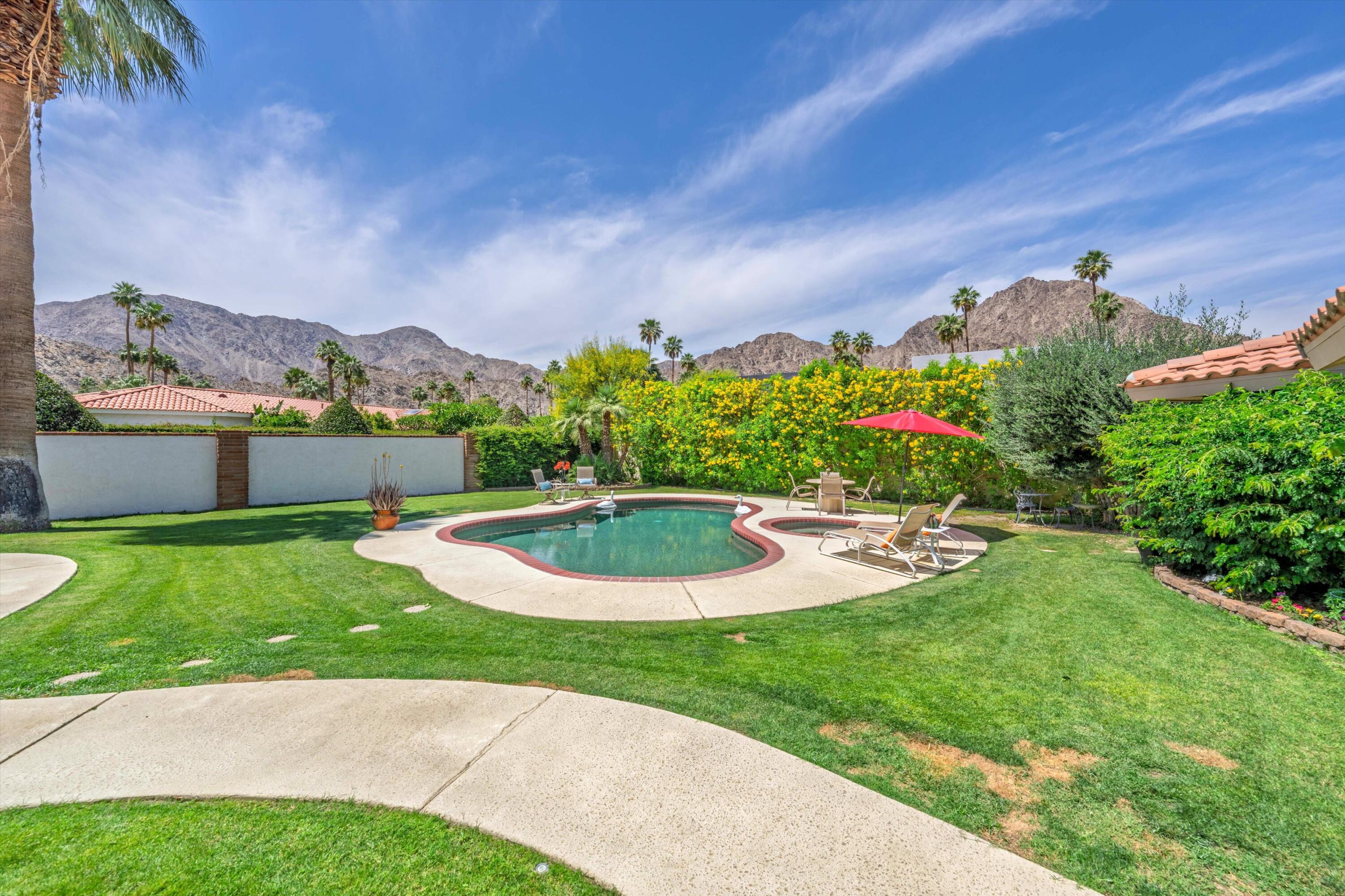 48800 Ave Anselmo La Quinta, CA 92253 - Photo 8 of 44 a view of a garden with a house