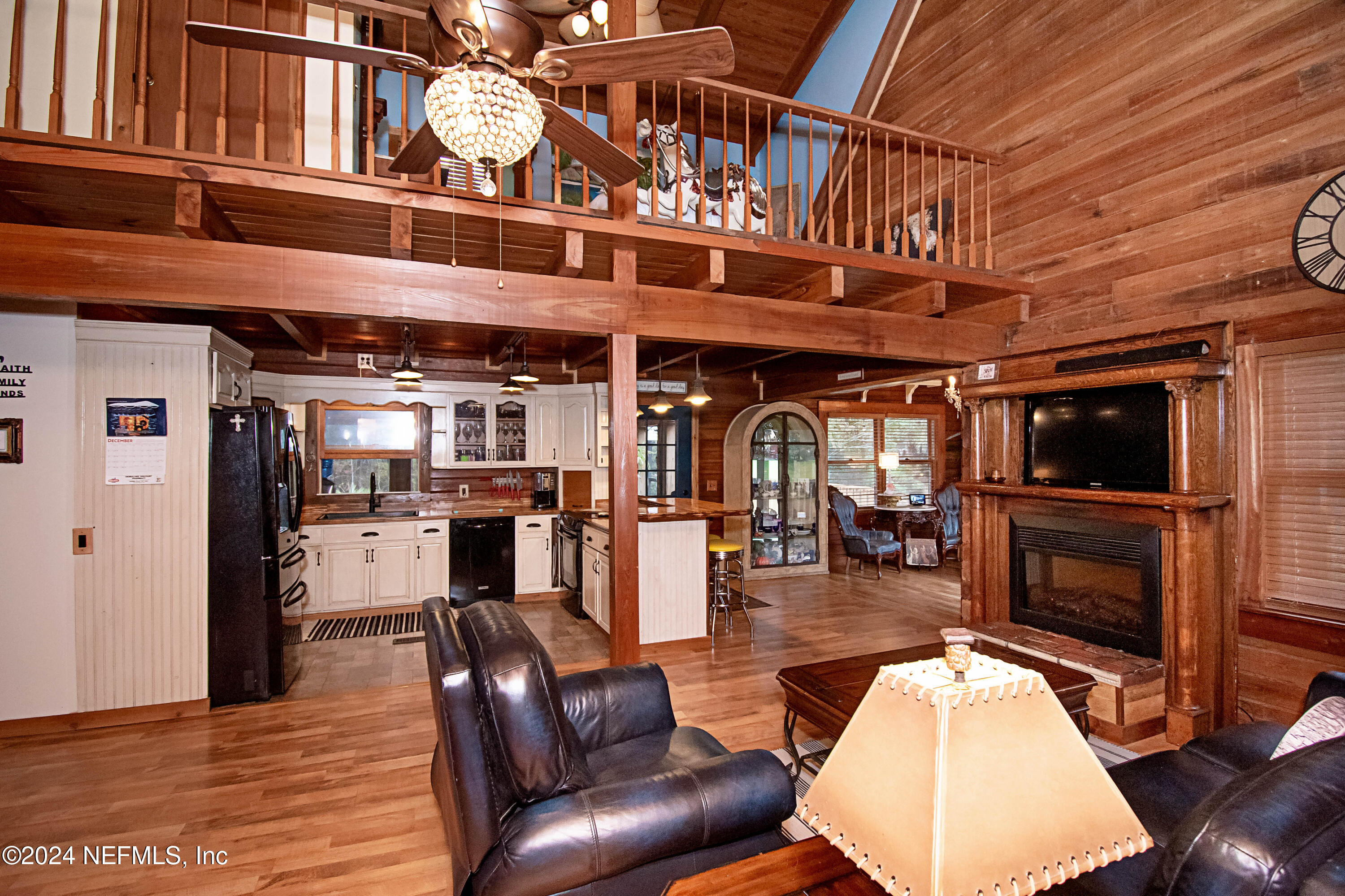 149 Rhoden Drive Macclenny, FL 32063 - Photo 20 of 63 a living room with furniture a flat screen tv and kitchen view