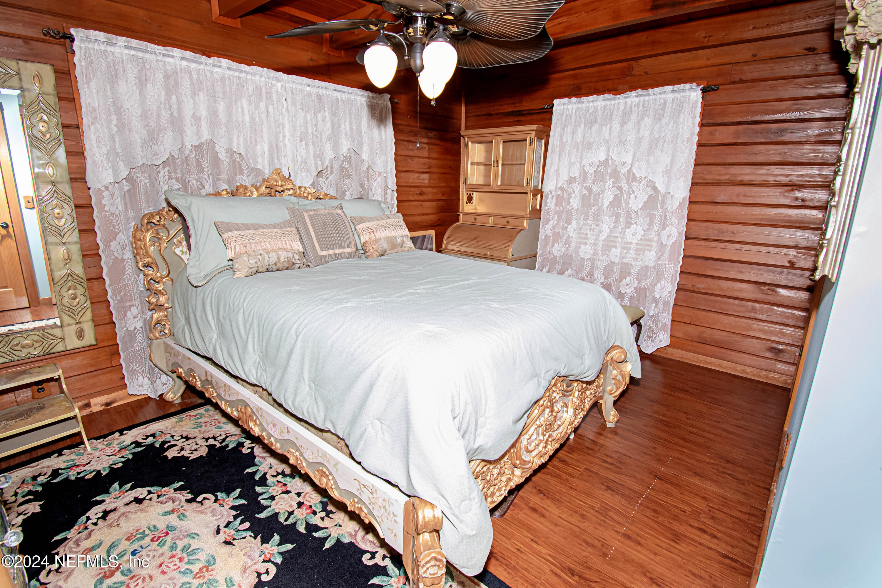 149 Rhoden Drive Macclenny, FL 32063 - Photo 23 of 63 a bedroom with a bed and wooden floor
