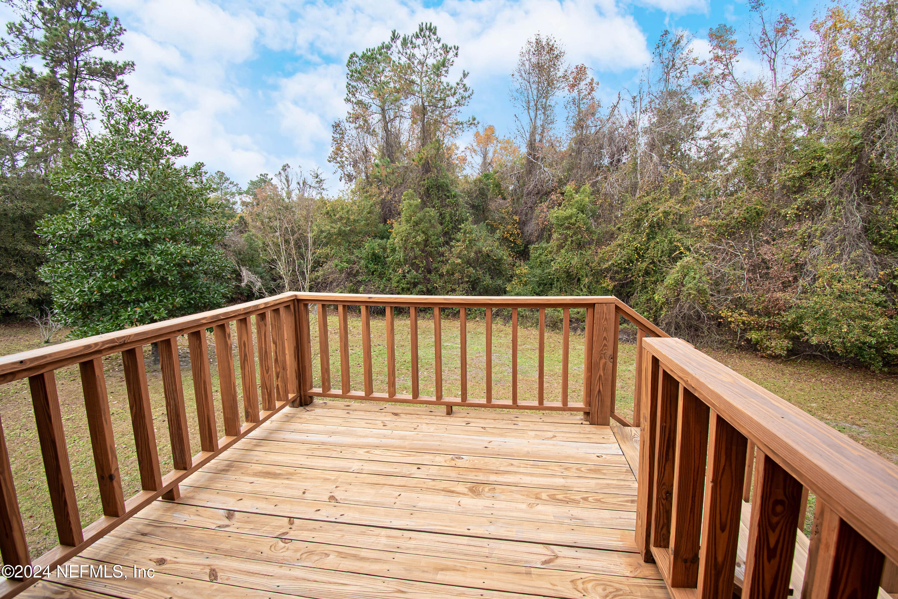149 Rhoden Drive Macclenny, FL 32063 - Photo 38 of 63 a balcony view with wooden floor and fence