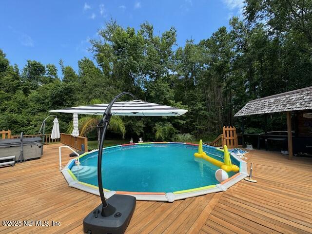149 Rhoden Drive Macclenny, FL 32063 - Photo 42 of 63 a view of a swimming pool with a patio