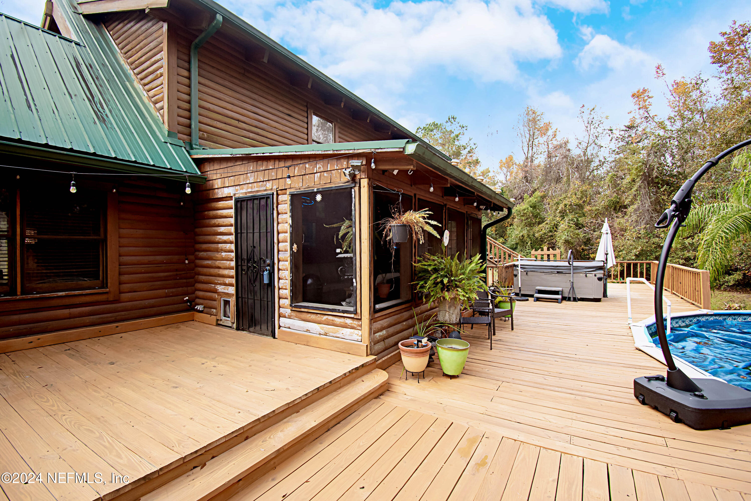 149 Rhoden Drive Macclenny, FL 32063 - Photo 48 of 63 a view of a patio with table and chairs with wooden floor and fence