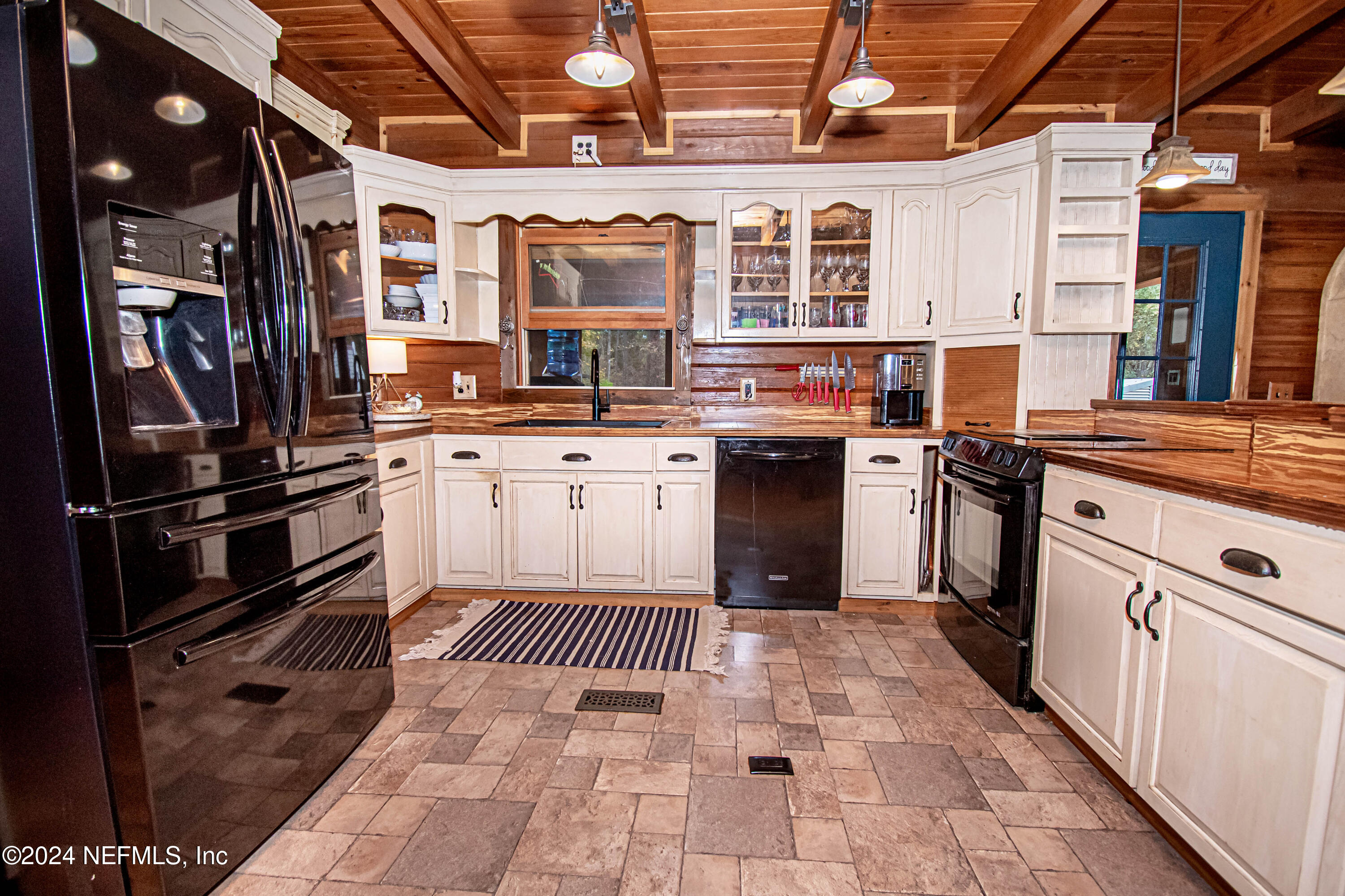 149 Rhoden Drive Macclenny, FL 32063 - Photo 10 of 63 a kitchen with stainless steel appliances granite countertop a stove a sink dishwasher and cabinets