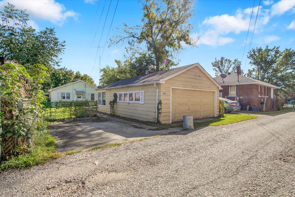 703 Oakland Avenue Joliet, IL 60435 - Photo 13 of 13 a view of a house with backyard and a tree