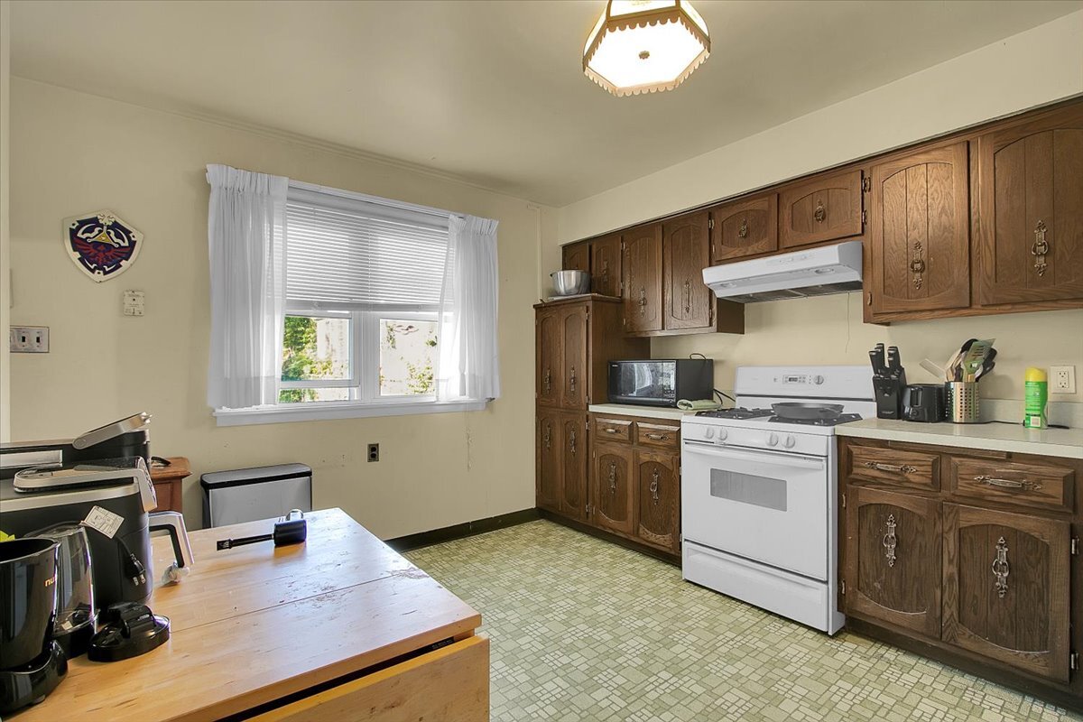 703 Oakland Avenue Joliet, IL 60435 - Photo 6 of 13 a kitchen with a sink stove and refrigerator