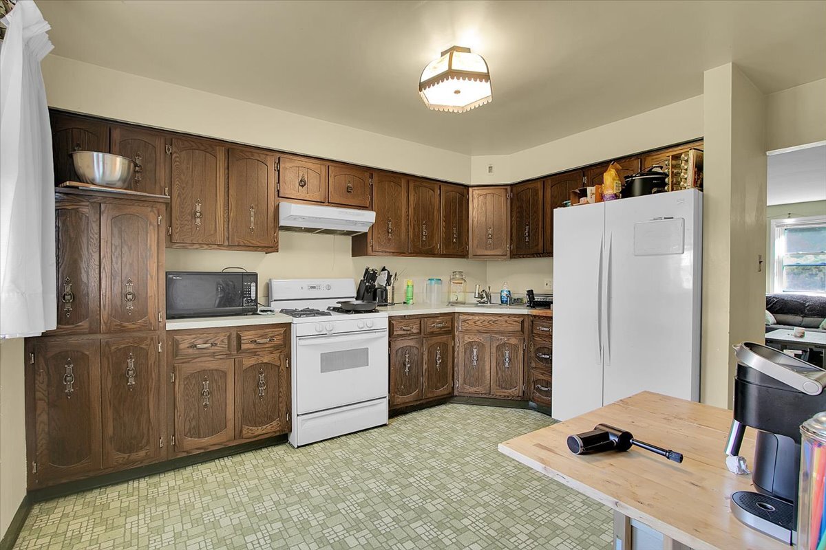 703 Oakland Avenue Joliet, IL 60435 - Photo 7 of 13 a kitchen with a refrigerator and a stove