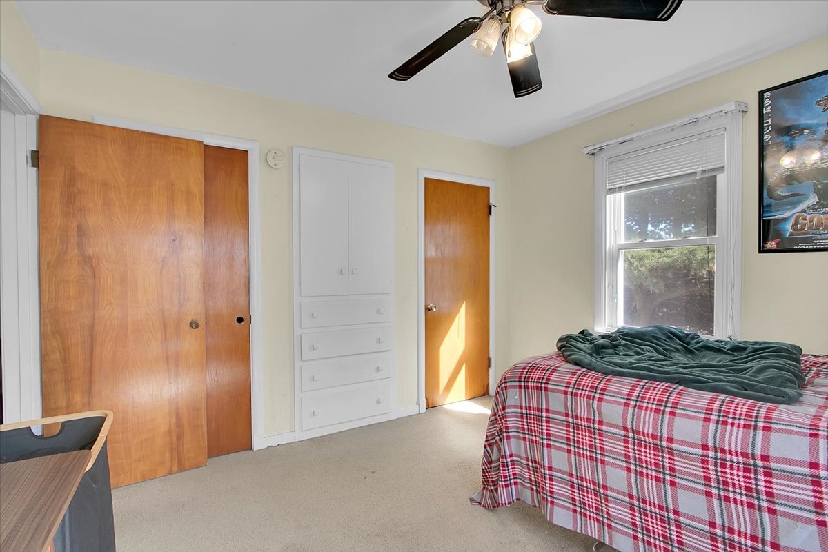 703 Oakland Avenue Joliet, IL 60435 - Photo 9 of 13 a bedroom with a bed and a mirror